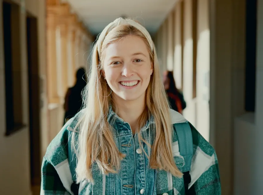 Smiling girl in a school corridor