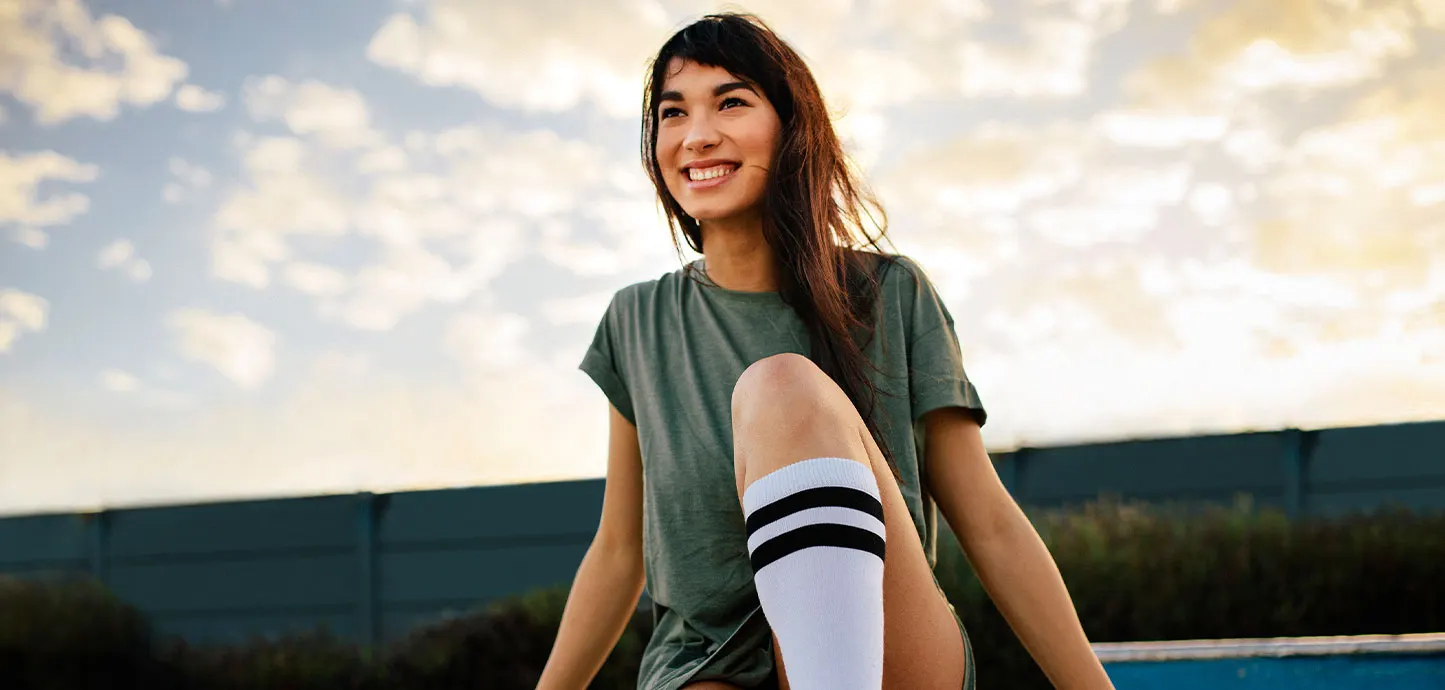 Smiling young woman sitting outdoors